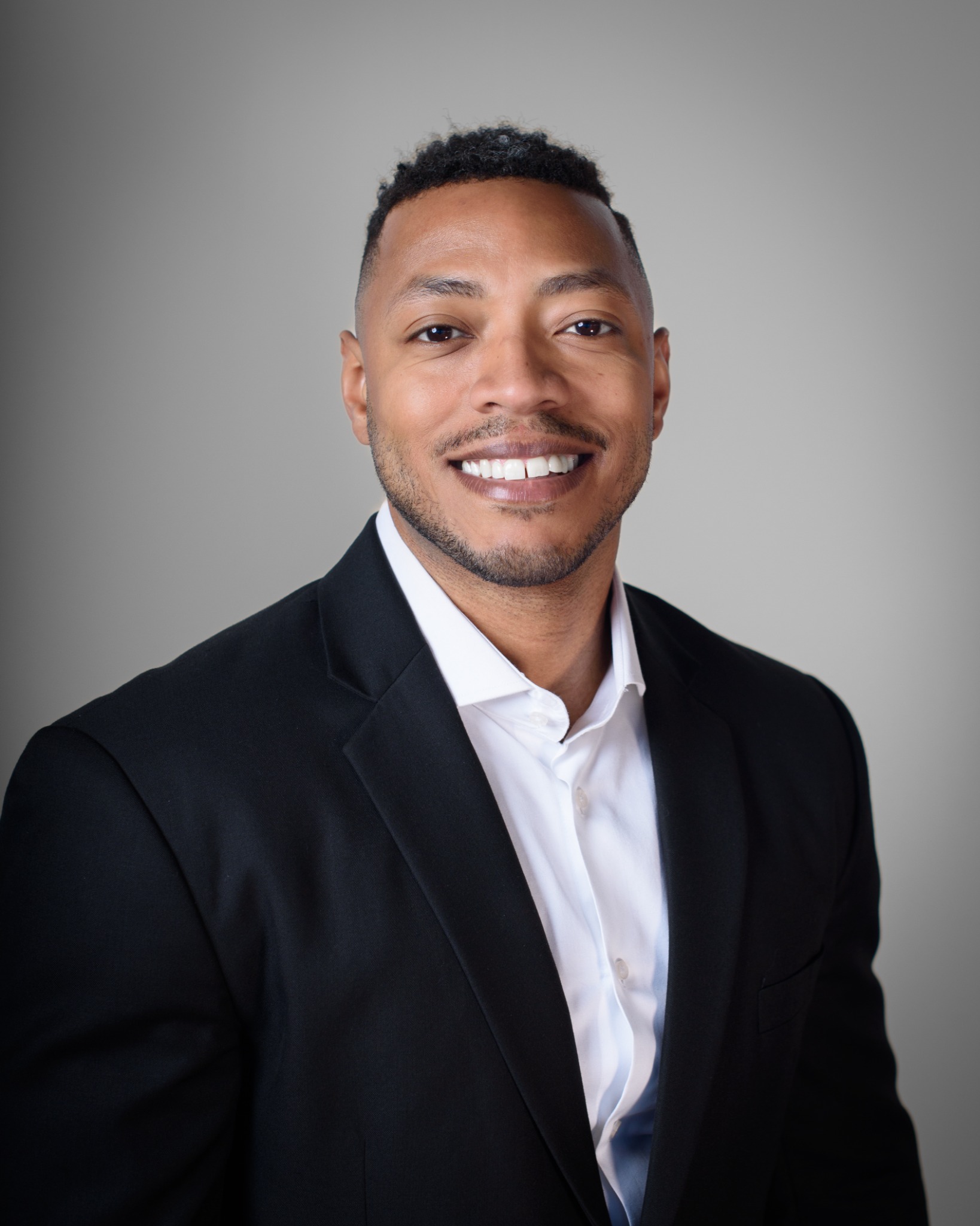 Jadrien Brown smiling in a black jacket